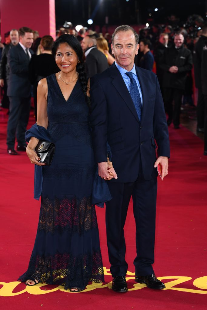Robson Green in a blue suit with partner Zoila in a blue lace dress