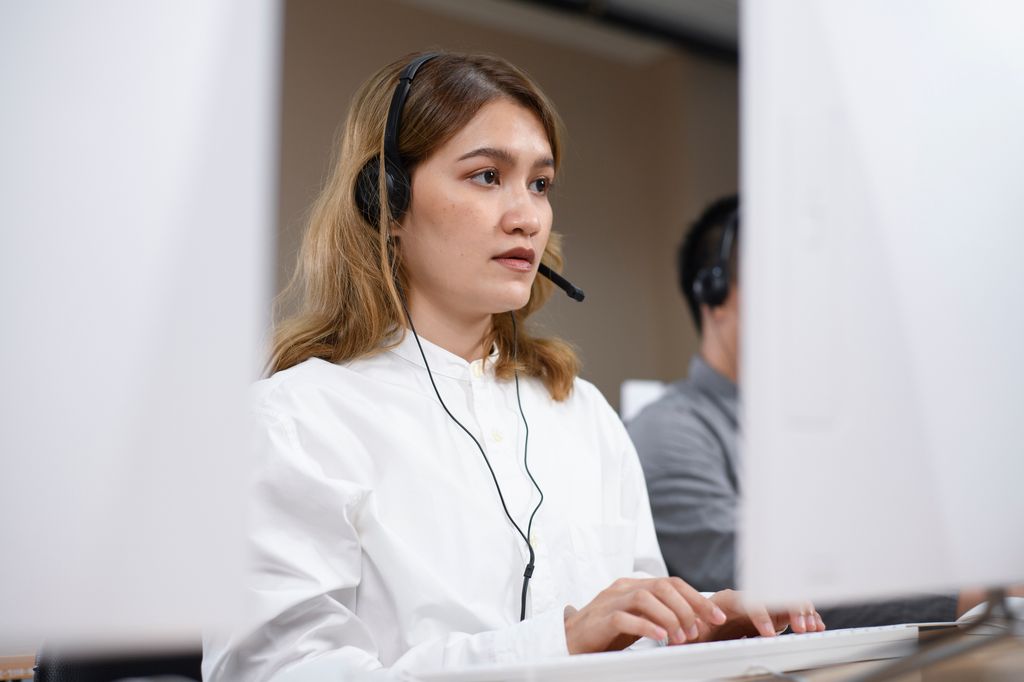 young woman using computer and headset