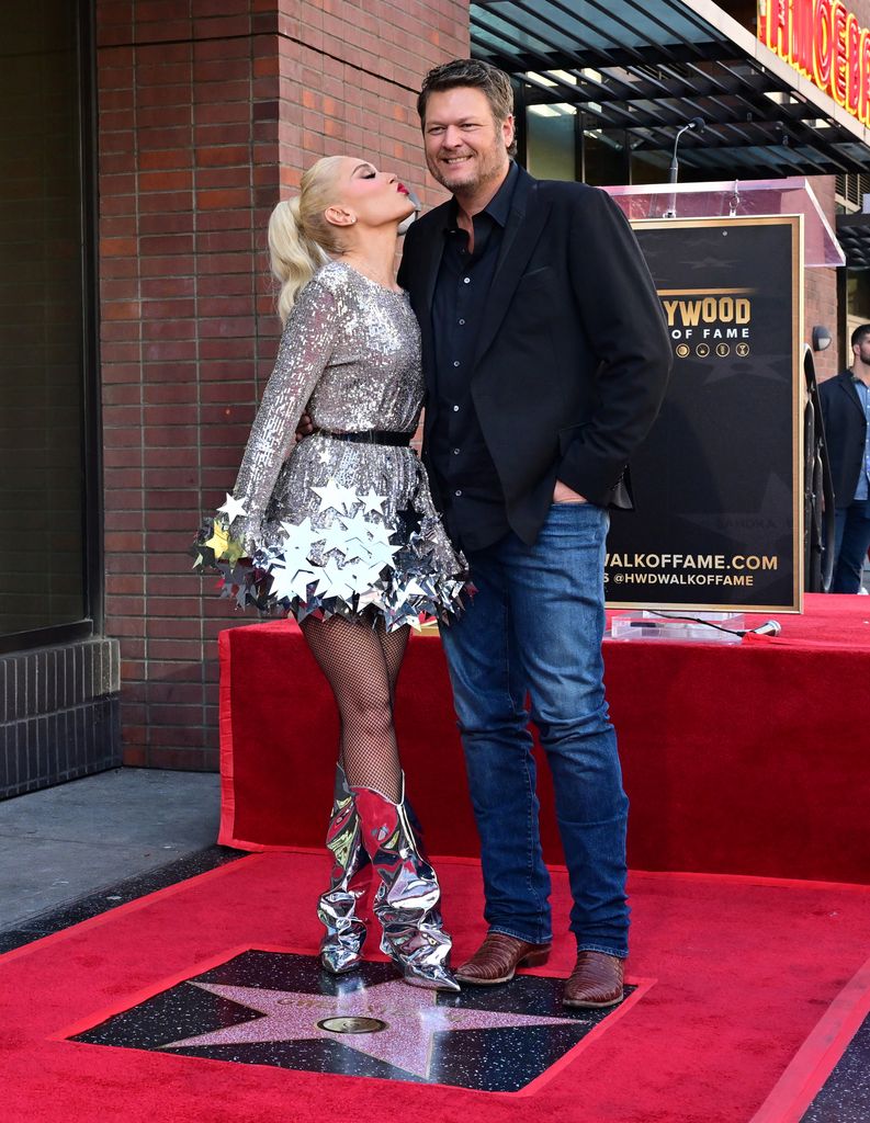 US singer Gwen Stefani puckers up to kiss her husband Blake Shelton at her Hollywood Walk of Fame Star ceremony in Hollywood, California, on October 19, 2023. (Photo by Frederic J. BROWN / AFP) (Photo by FREDERIC J. BROWN/AFP via Getty Images)