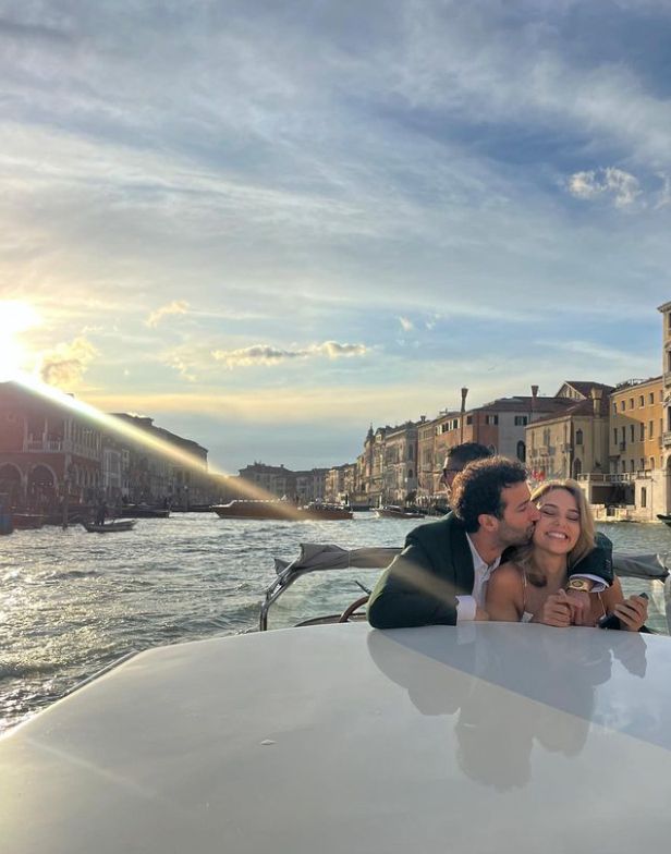 Daniel Ricciardo and Heidi Berger on a boat, with Daniel kissing her