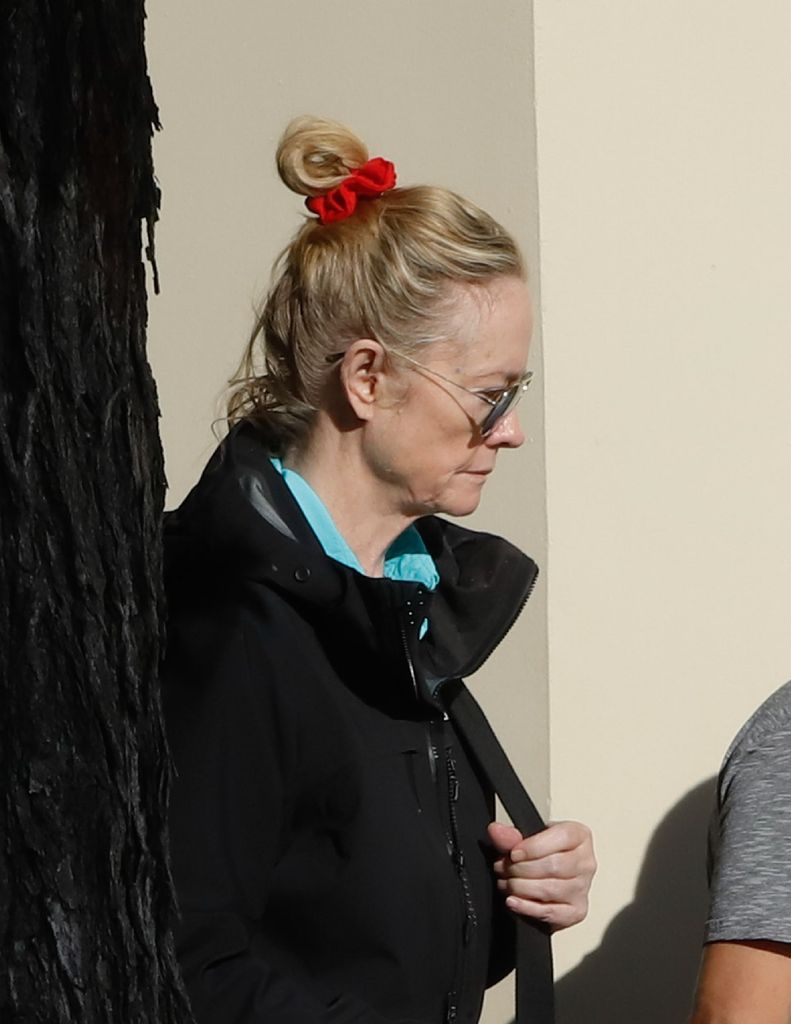 Cybill looks casual walking with hair in a scrunchie and big sunglasses