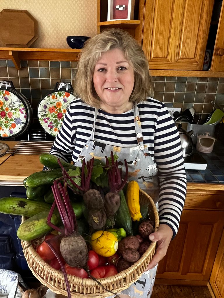 Lady holding a basket of vegetables