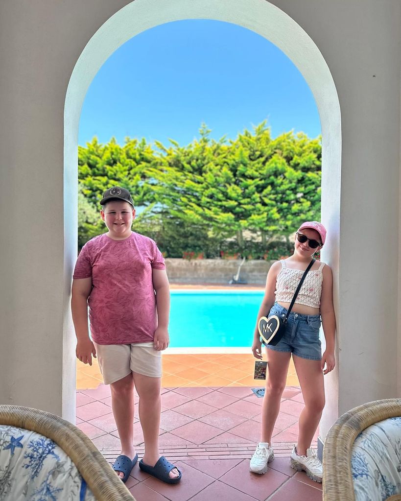 brother and sister leaning in archway in villa