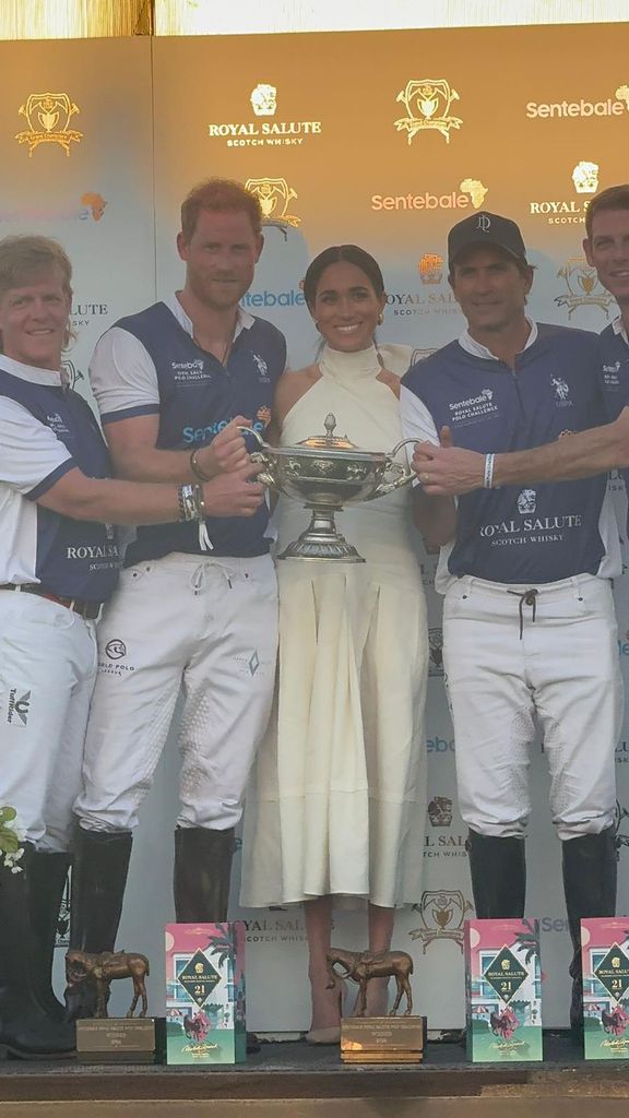 The Sentebale team accept their trophy from Mheeghan Markle