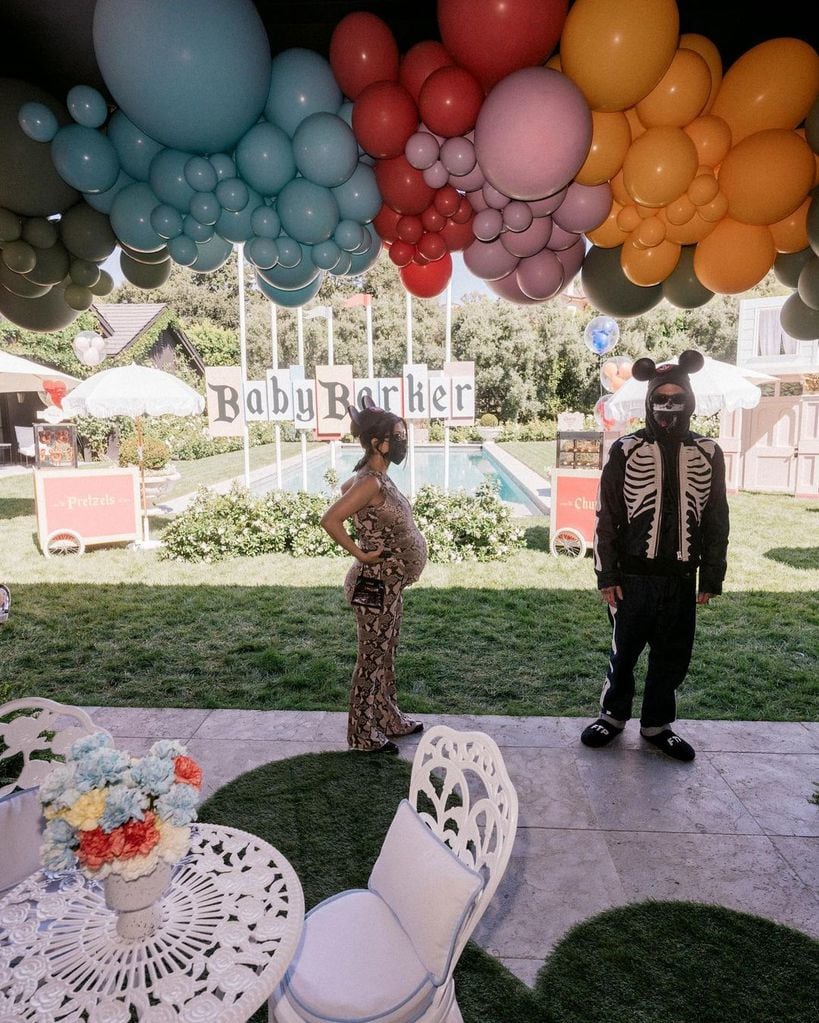 Travis and Kourtney at the baby shower standing at a distance from eachother