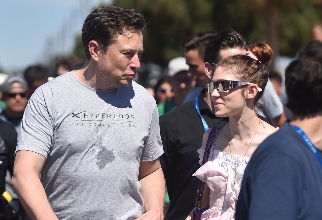 Grimes and Elon Musk walking together outside