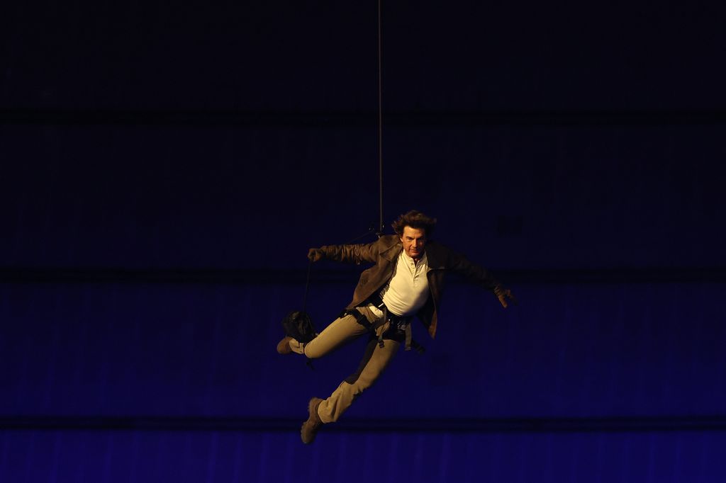 US' actor Tom Cruise lands on the roof of one of the stadium entrances during the closing ceremony of the Paris 2024 Olympic Games at the Stade de France, in Saint-Denis, in the outskirts of Paris, on August 11, 2024.