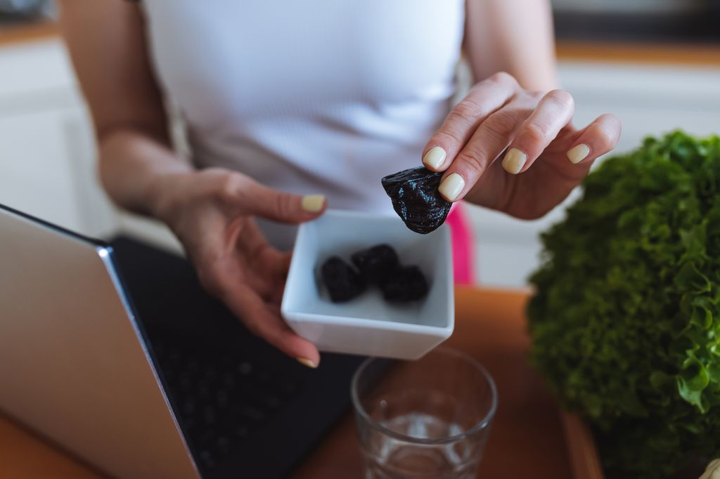 woman eating prunes