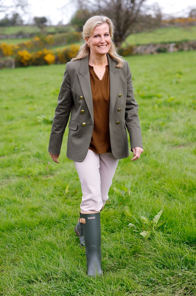 Sophie Wessex walking in a field in wellies