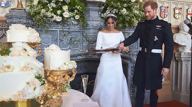 Meghan and Harry cutting their wedding cake with a sword