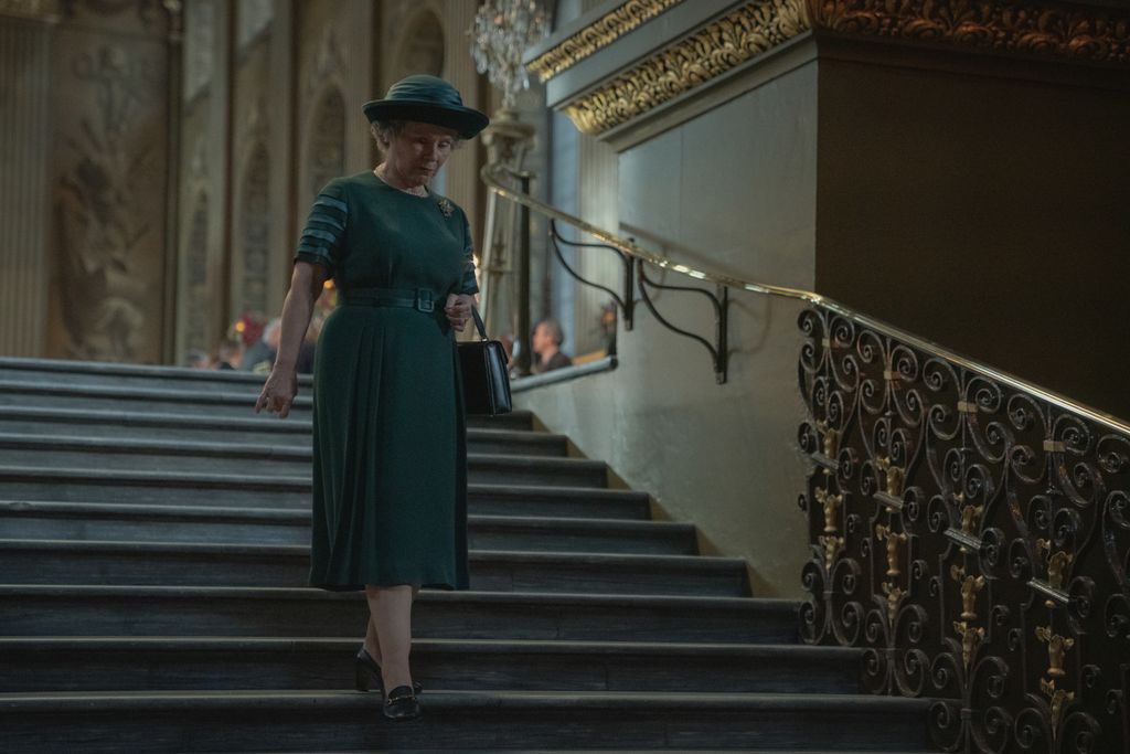 Imelda Staunton walks down stairs as Queen Elizabeth II in The Crown