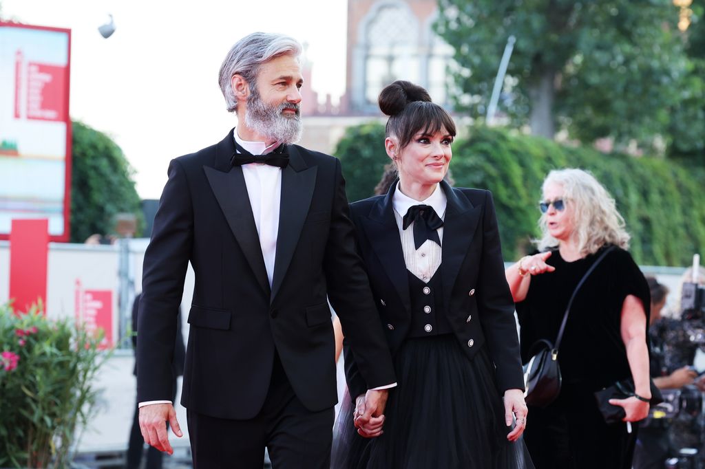 Scott Mackinlay Hahn and  Winona Ryder attend a red carpet for the movie "Beetlejuice Beetlejuice" during the 81st Venice International Film Festival at  on August 28, 2024 in Venice, Italy.