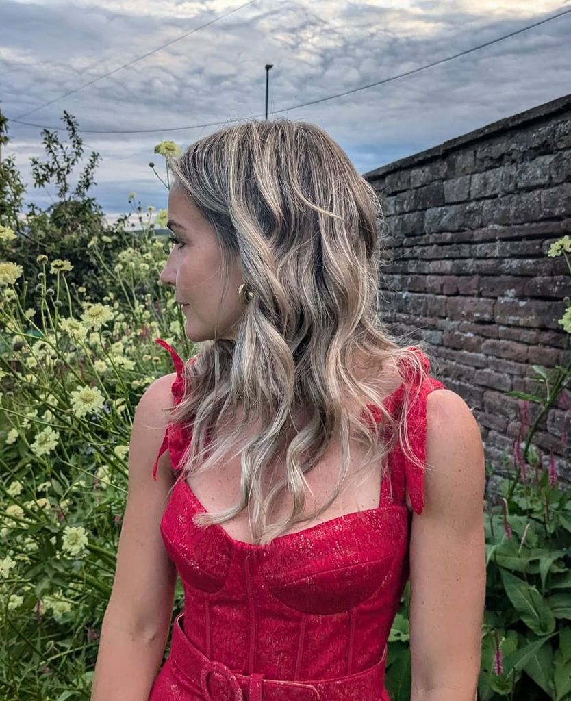 Helen Skelton looks away in red dress