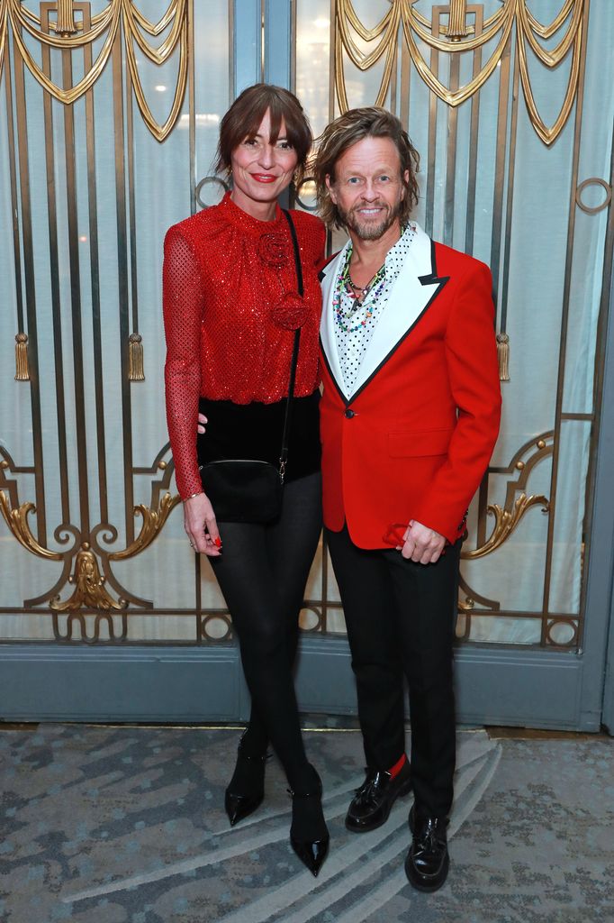 davina McCall and Michael Douglas in red outfits smiling