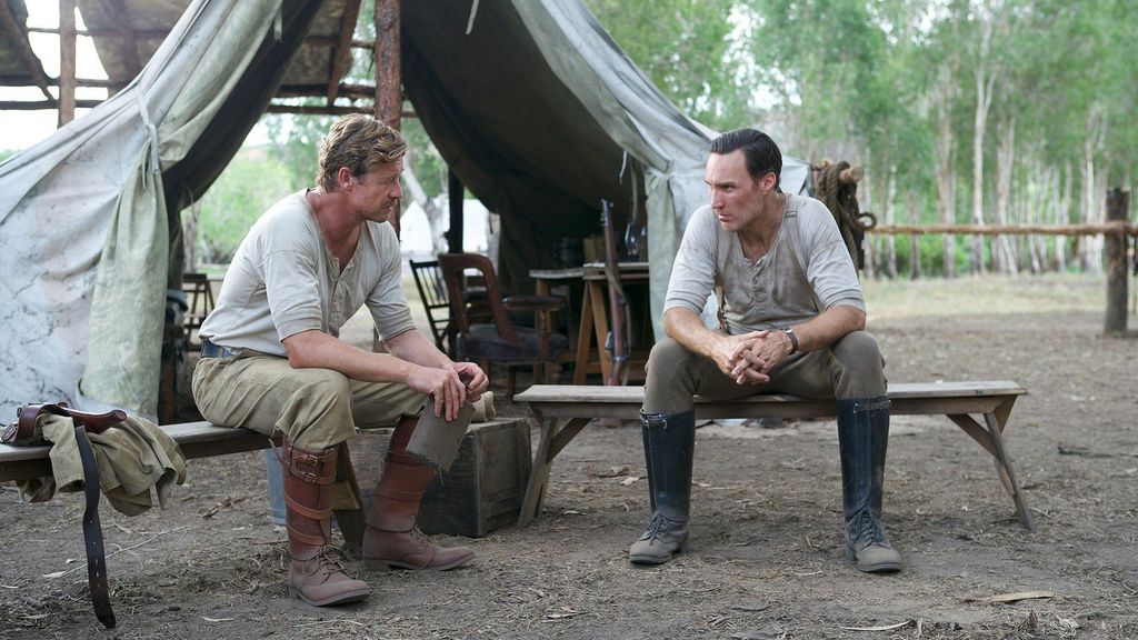 Simon Baker sitting with Callan Mulvey in High Ground