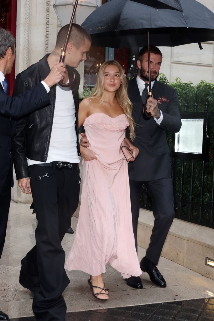 David Beckham and Romeo helped Harper as they navigated the rain