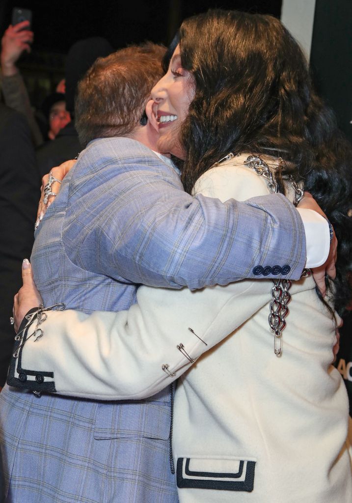 Chaz Bono and Cher hugging on the red carpet