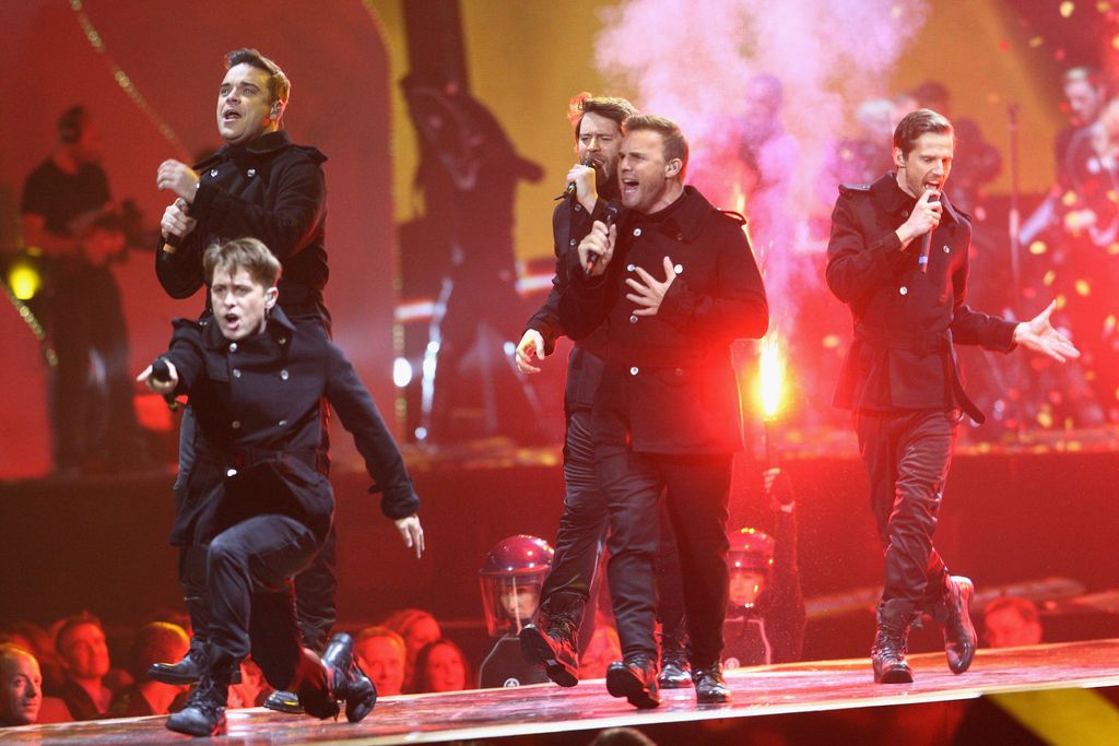 Gary Barlow, Jason Orange, Mark Owen, Howard Donald and Robbie Williams of Take That perform onstage