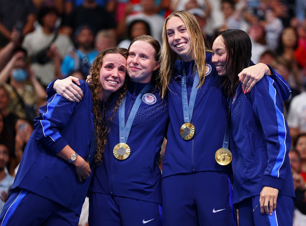 Gold Medalists Regan Smith, Lilly King, Gretchen Walsh and Torri Huske of Team United States celebrate on the podium during the Swimming medal ceremony after the Womenâs 4x100m Medley Relay Final on day nine of the Olympic Games Paris 2024 at Paris La Defense Arena on August 04, 2024 in Nanterre, France.