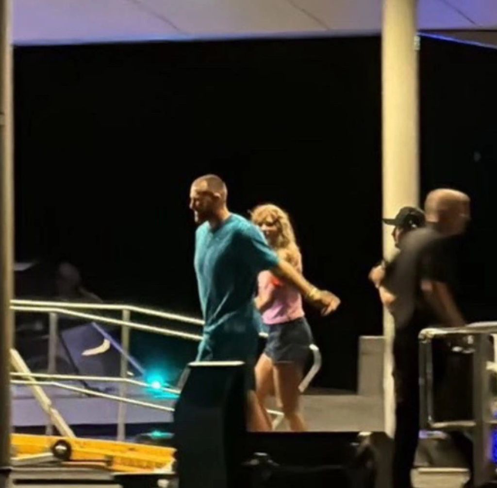 Taylor and Travis walked hand in hand onto their boat