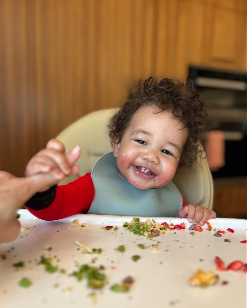 Wren Stephens eating in high chair