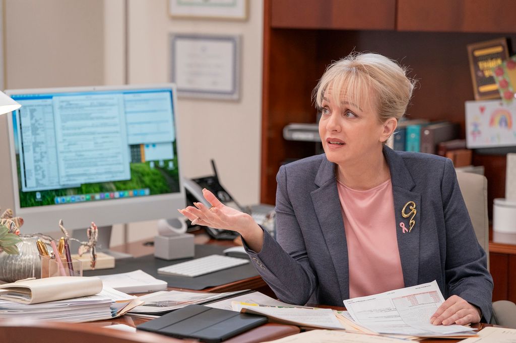 woman sitting behind desk in front of computer