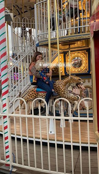 Carrie Johnson and Wilfred on a merry go round