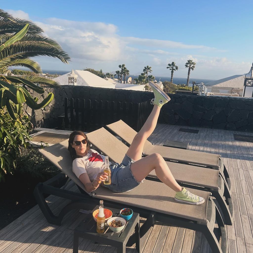 woman wearing denim shorts on sun lounger