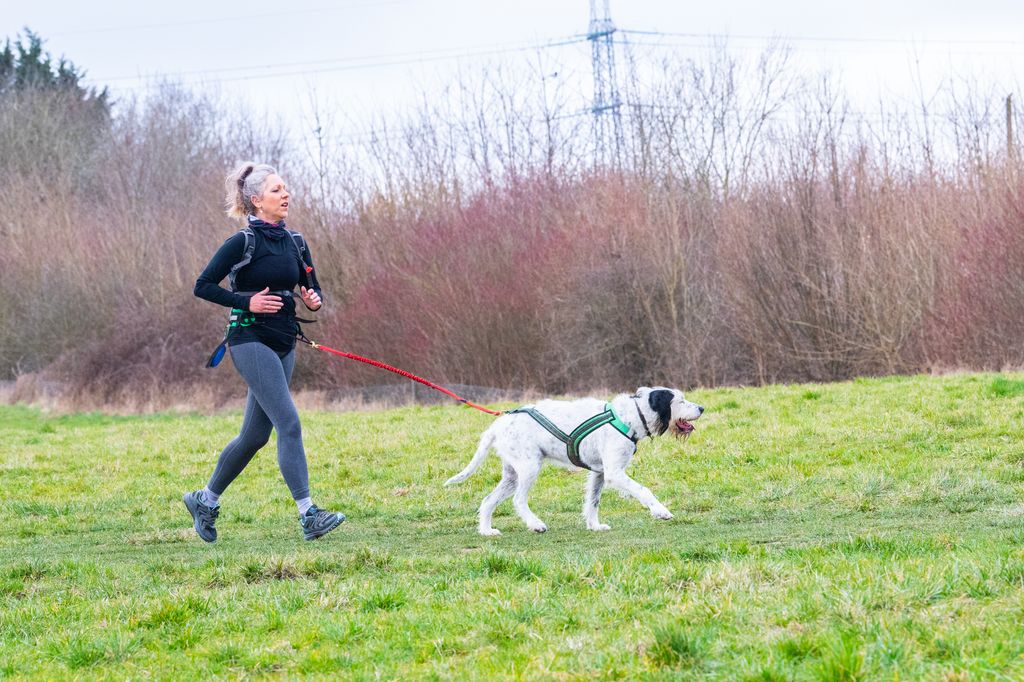 Lady running with her dog on a lead