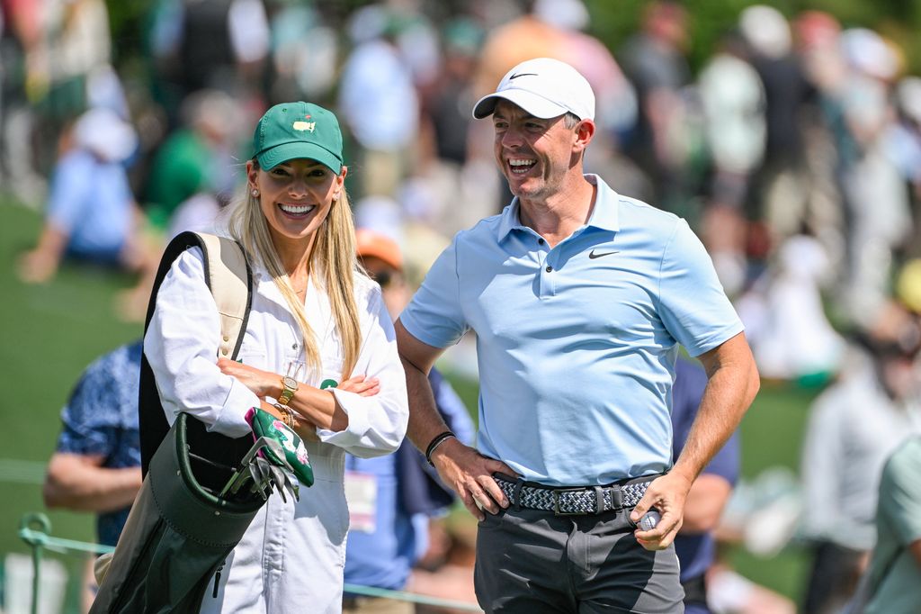 Rory McIlroy and Erica Stoll smiling together on the golf course