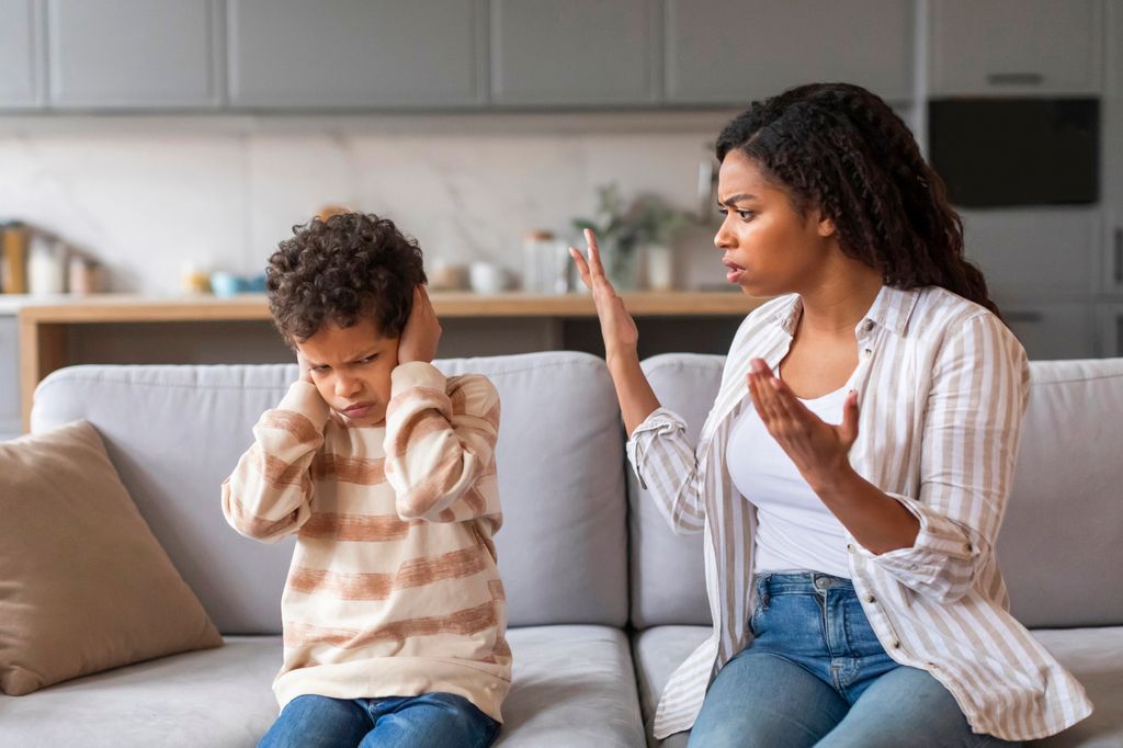  mother speaking with strong willed child having a tantrum