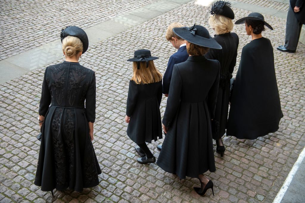 Sophie, Kate, Charlotte, Camilla and Meghan curtsy as the Queen's coffin passes