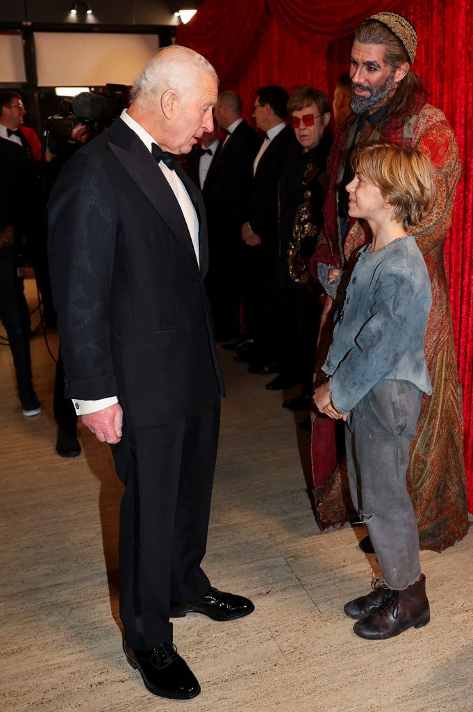 Britain's King Charles III meets meets Jack Philpott, the actor who plays Oliver in 'Oliver! The Musical' 