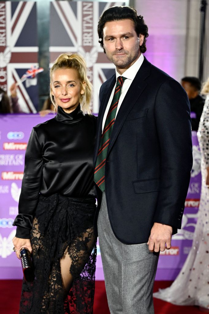 Louise Redknapp in black and Drew Michael on red carpet 