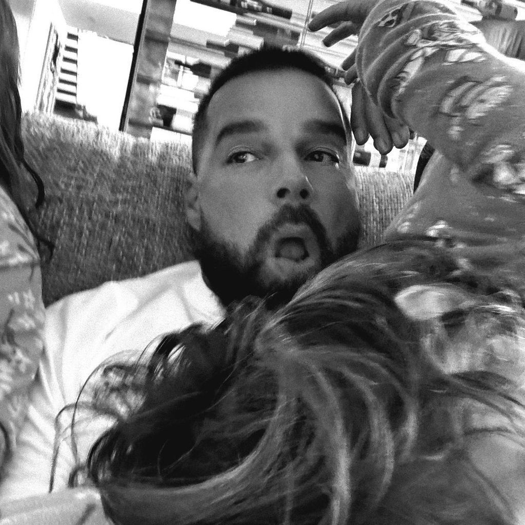 Ricky Martin shares a selfie of himself with his two youngest children Lucia and Renn on the couch in their home, shared on Instagram