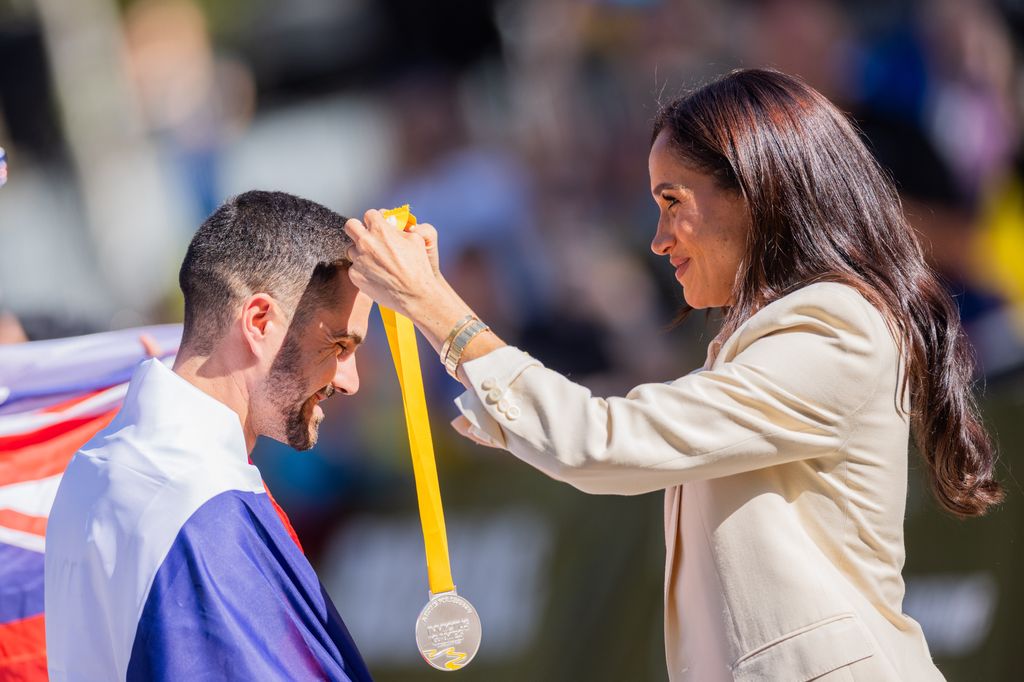 Meghan presents a medal to a participant