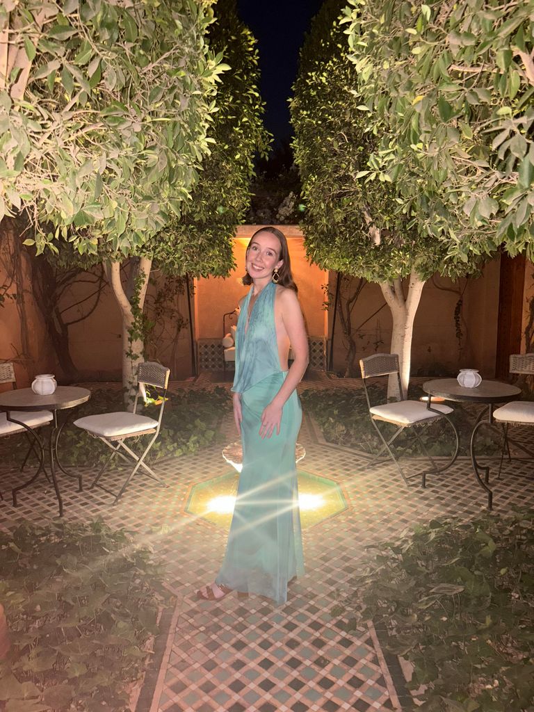 A girl in a dress standing in a patio garden