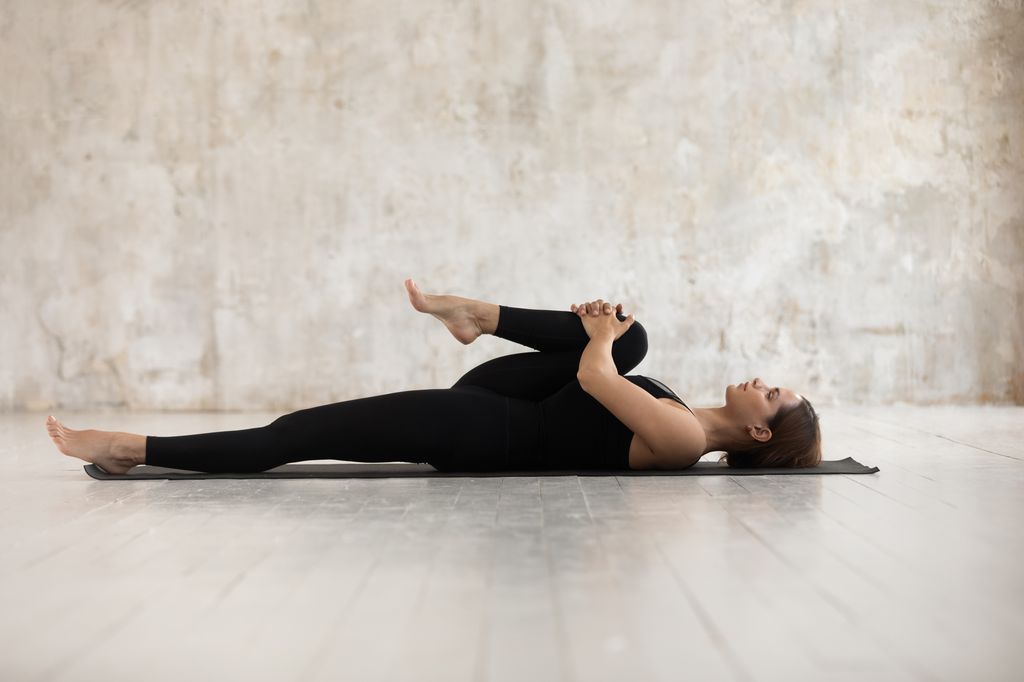 woman stretching on floor 