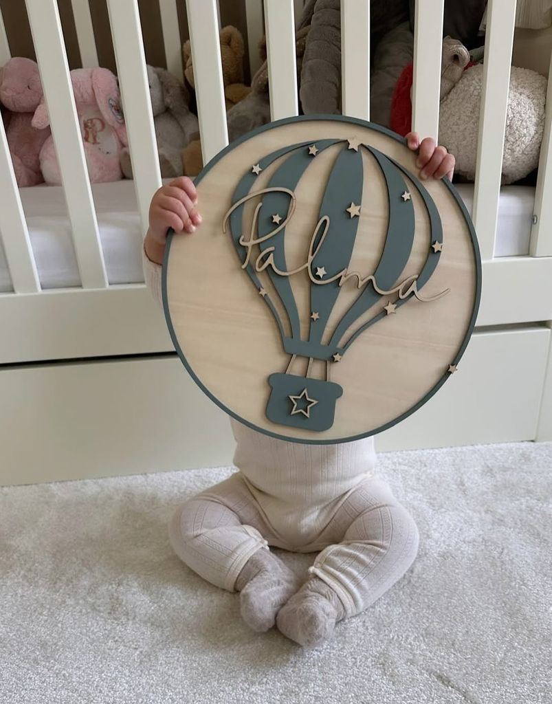 Michelle Keegan's daughter Palma holding up a large sign