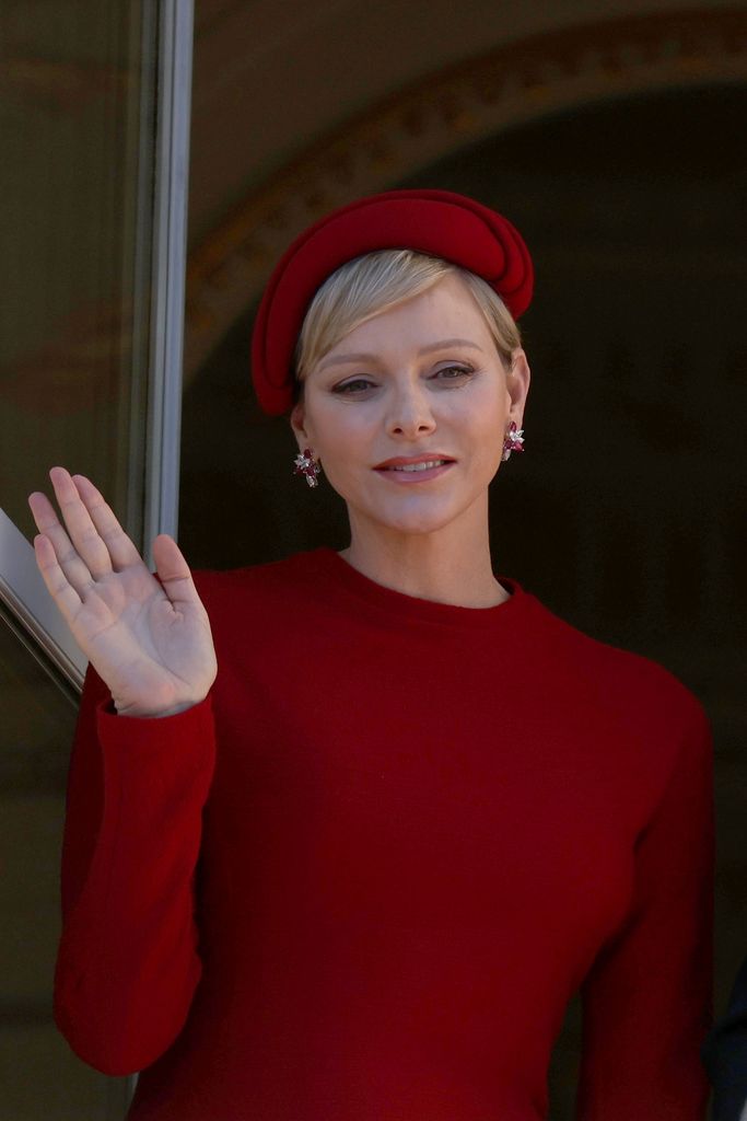 Princess Charlene waved from the Palais Princier, dazzlign in ruby and diamond earrings