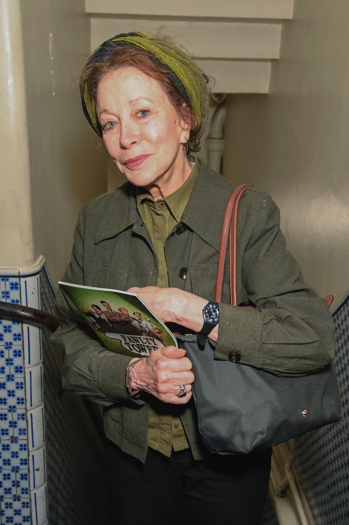 woman in green outfit at theatre