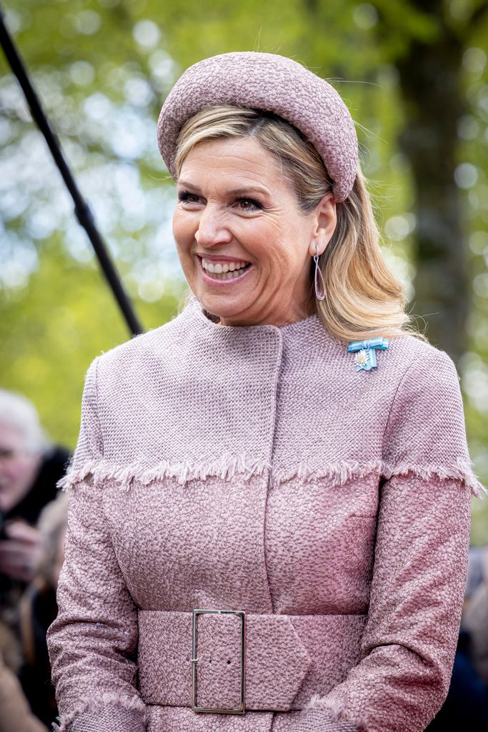 Queen Maxima wearing a tweed headband smiling