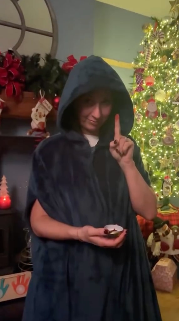 woman in cloak in lounge at christmas