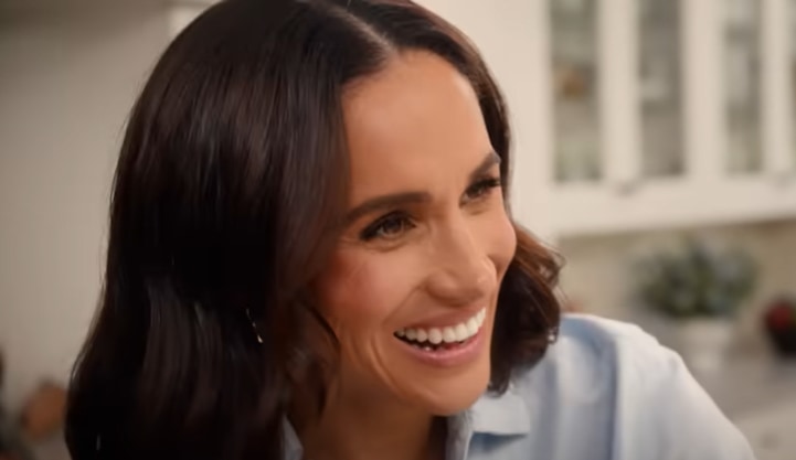 Meghan Markle wearing a blue shirt and smiling in the Netflix show