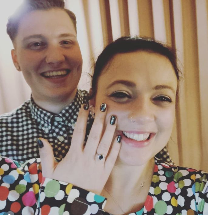 A man and a woman with an engagement ring