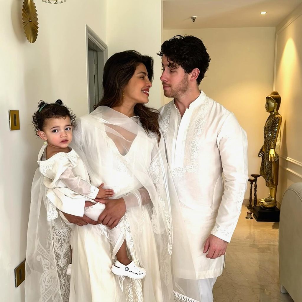 nick jonas with priyanka holding malti in white 