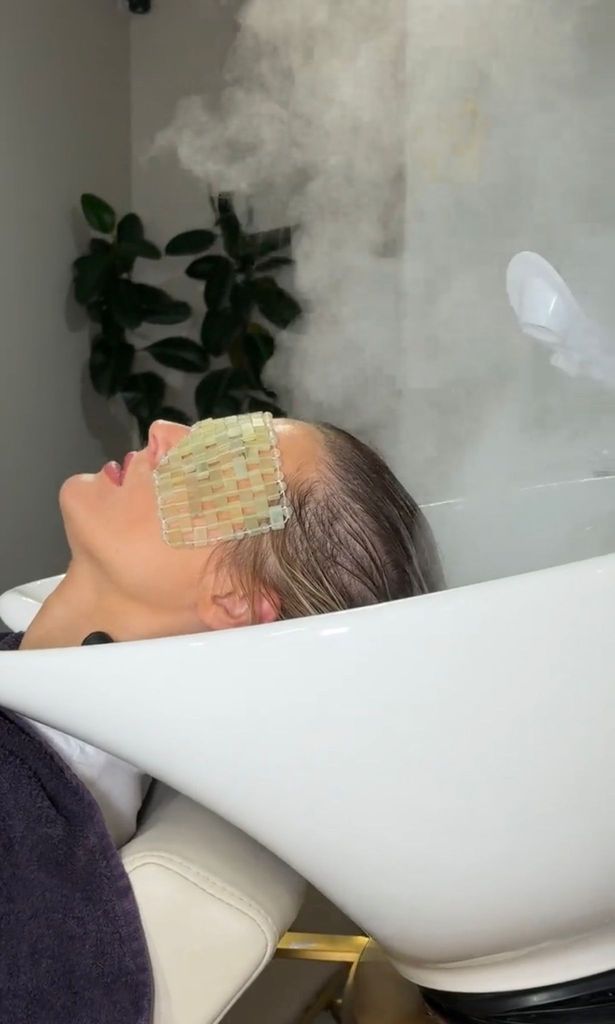 woman wearing a jade eye mask looking blisfully relaxed