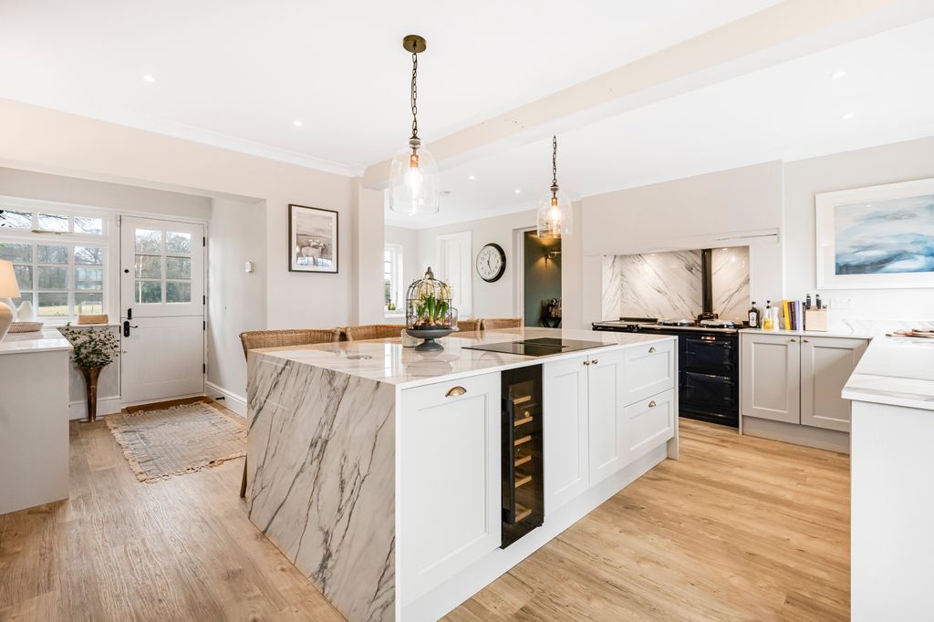 modern kitchen with white walls and wooden floors