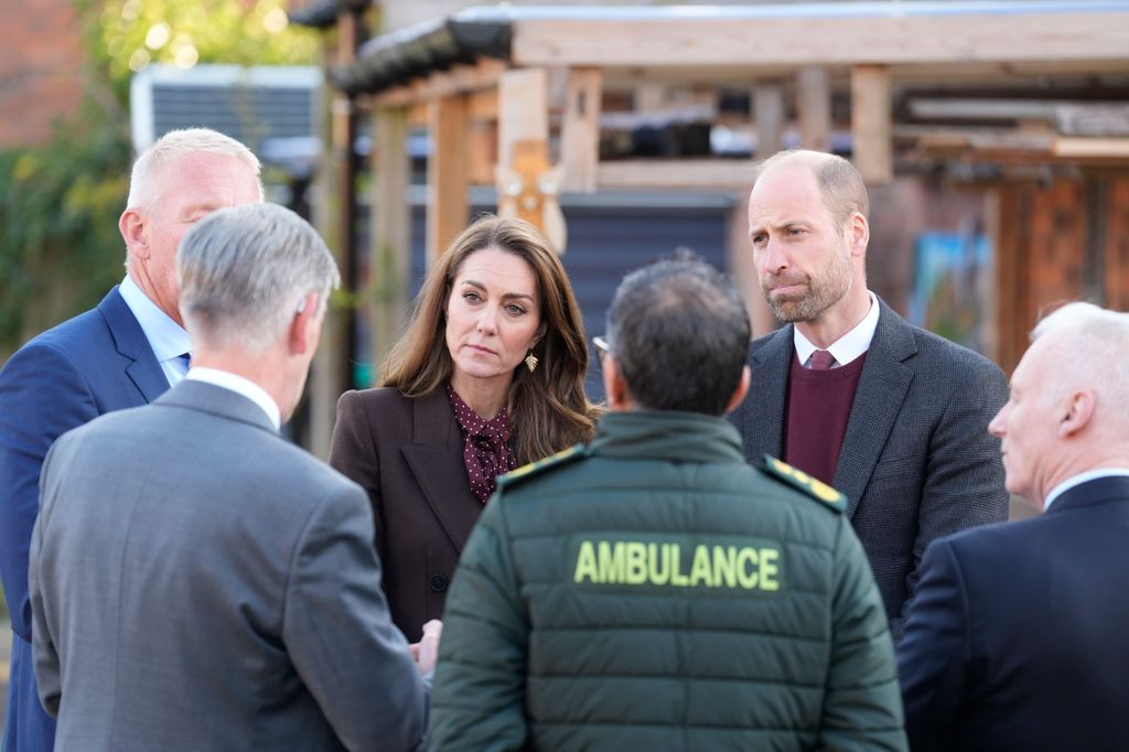 Prince William and Kate Middleton speak to members of the emergency services 