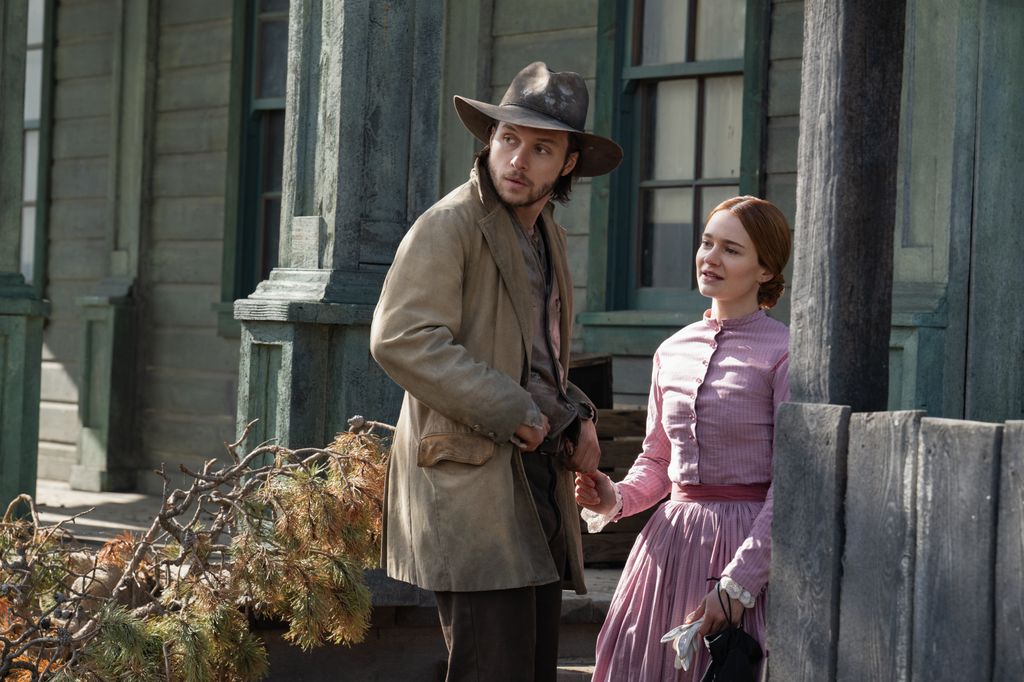 young man and woman holding hands in street